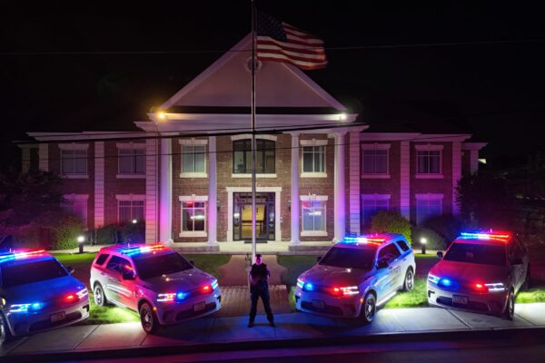Chief of Police with 4 Police Vehicles at City Hall